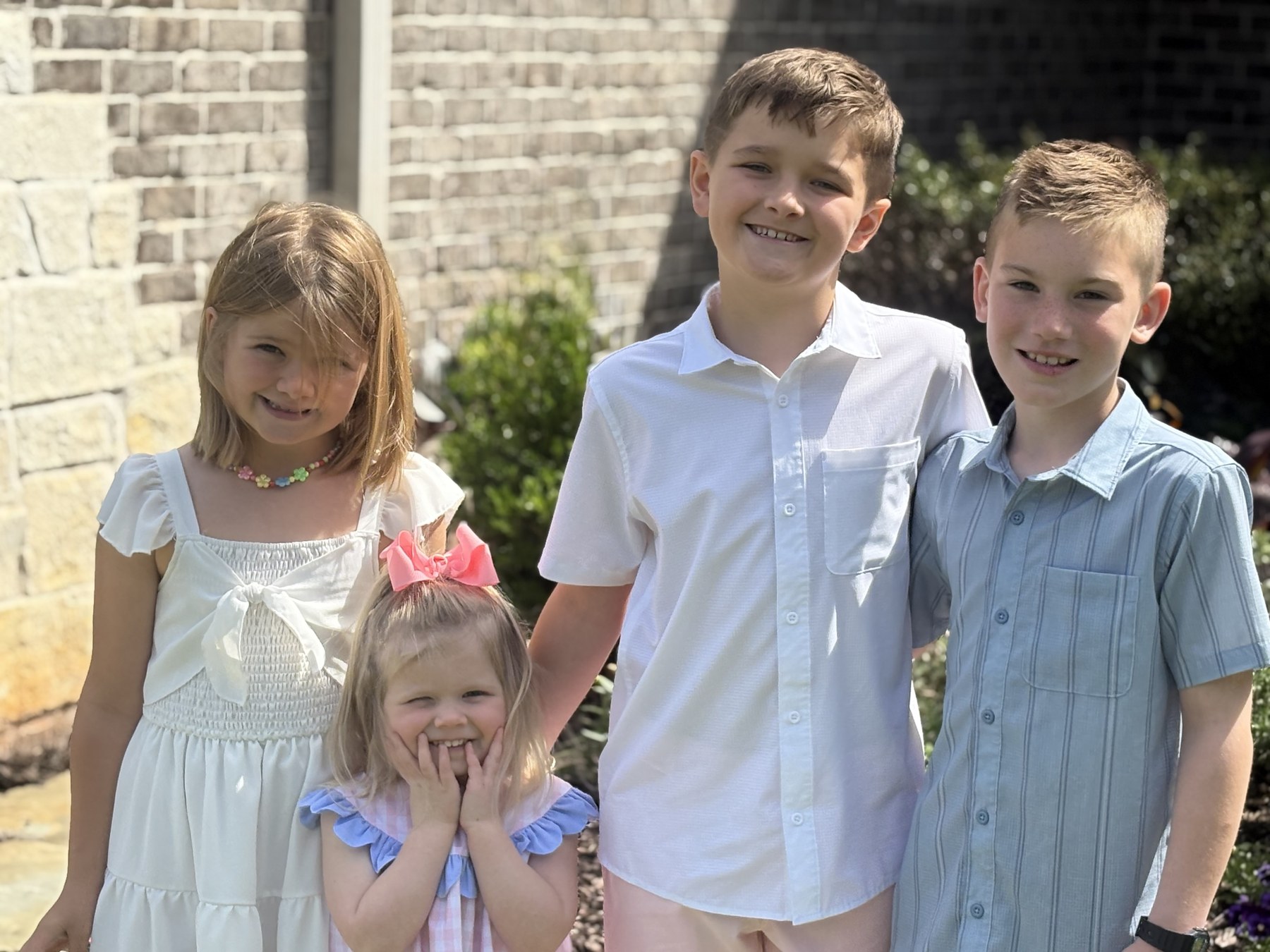 Dr. Craig Raschke’s children smiling outdoors